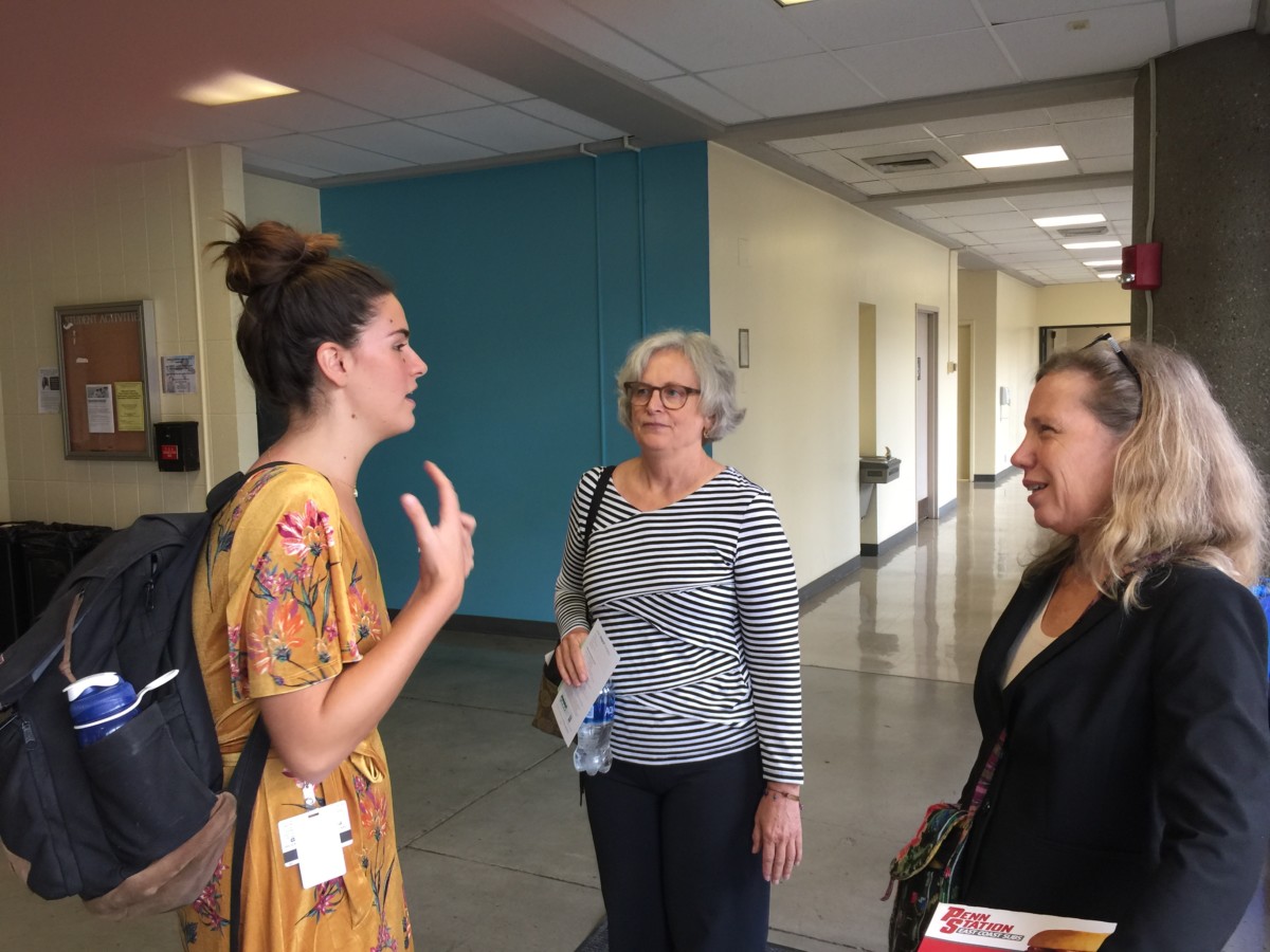 Drs. Carol Paris and Margaret Flowers speak with a medical student after the program.